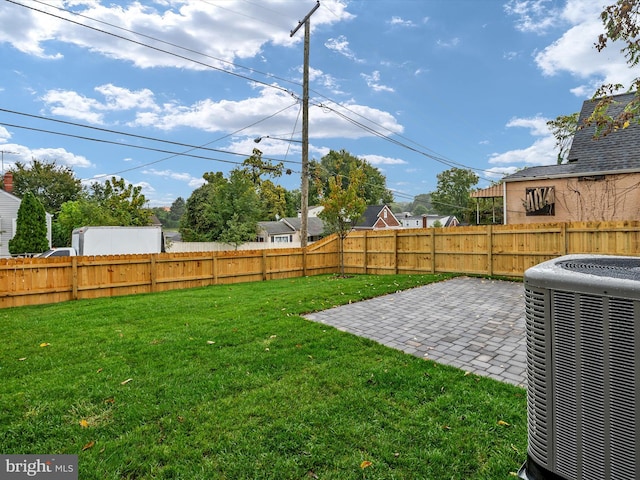 view of yard with a patio and central air condition unit