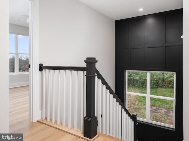 stairs with hardwood / wood-style flooring and plenty of natural light