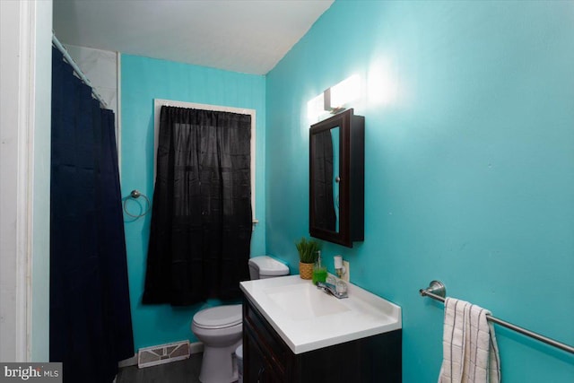 bathroom featuring toilet and vanity