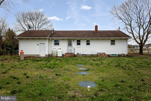 back of property with a lawn