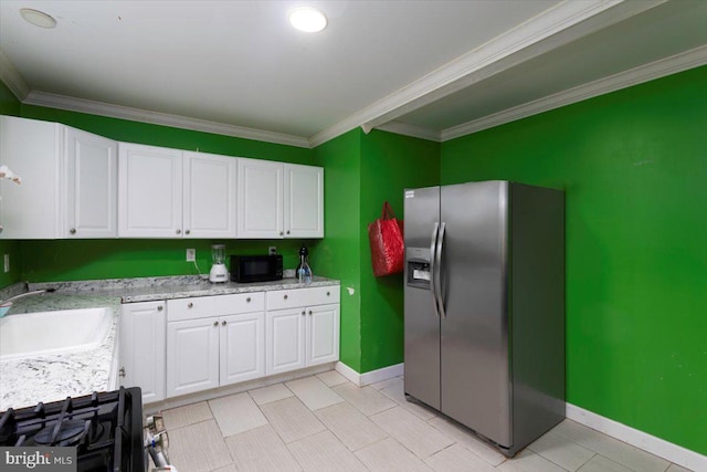 kitchen with stainless steel fridge, white cabinets, light tile floors, and crown molding