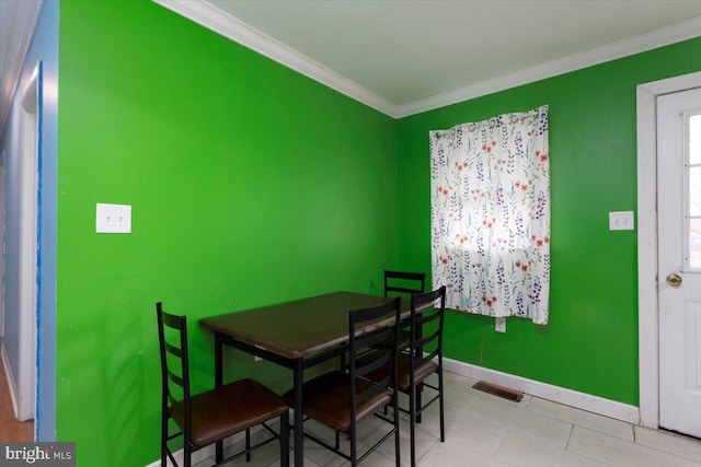 tiled dining area with crown molding