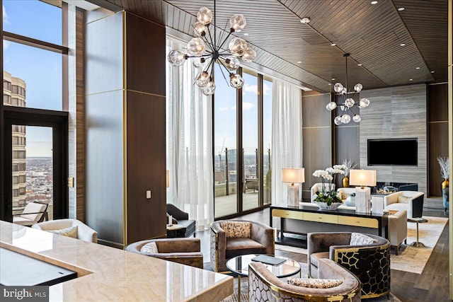 dining room with a towering ceiling, a large fireplace, dark wood-type flooring, wood ceiling, and a chandelier