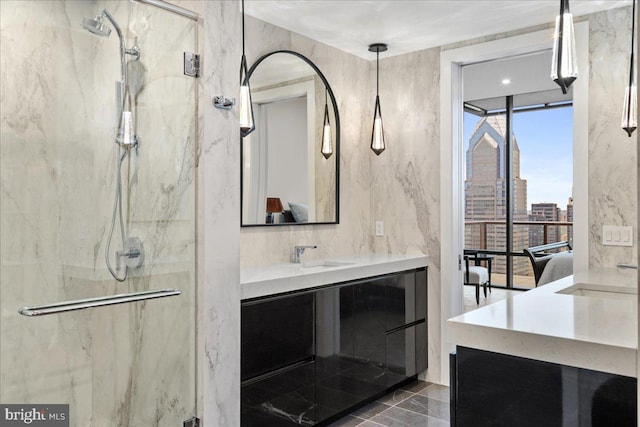 bathroom featuring vanity with extensive cabinet space and tiled shower