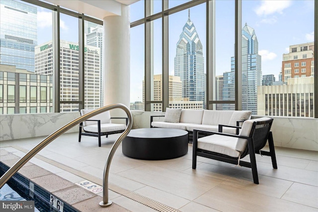 interior space with a wealth of natural light, a wall of windows, and light tile floors