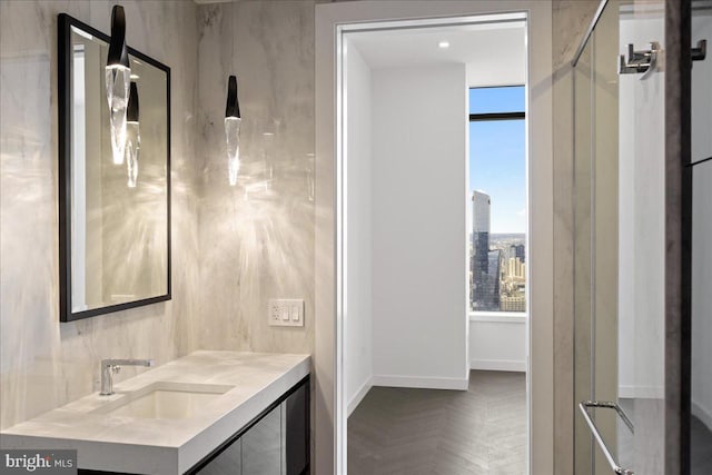 bathroom featuring a healthy amount of sunlight, parquet floors, and vanity