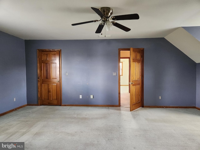 additional living space featuring light carpet, ceiling fan, and vaulted ceiling