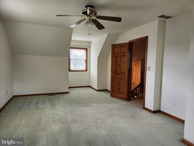 additional living space featuring ceiling fan, lofted ceiling, and light carpet