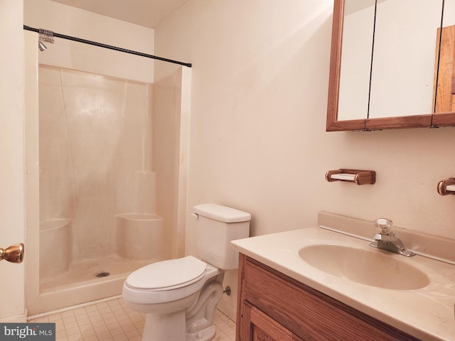 bathroom featuring a shower, tile patterned flooring, vanity, and toilet