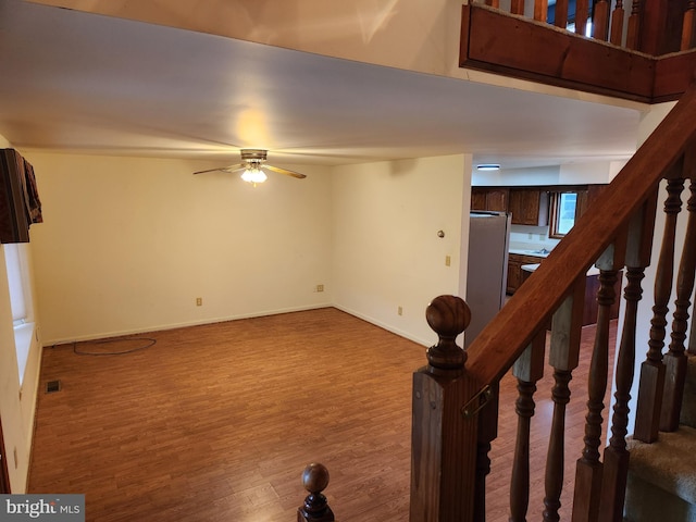 interior space featuring wood-type flooring and ceiling fan