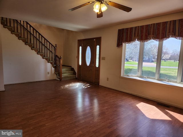 entrance foyer with ceiling fan and dark wood-type flooring