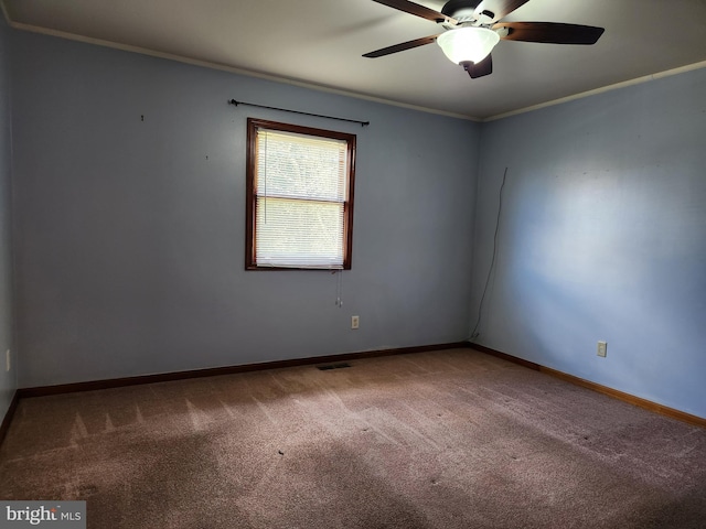 empty room featuring carpet floors, ceiling fan, and ornamental molding