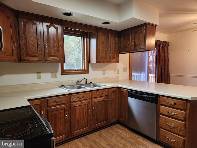 kitchen featuring dishwasher, kitchen peninsula, light hardwood / wood-style flooring, and range with electric stovetop