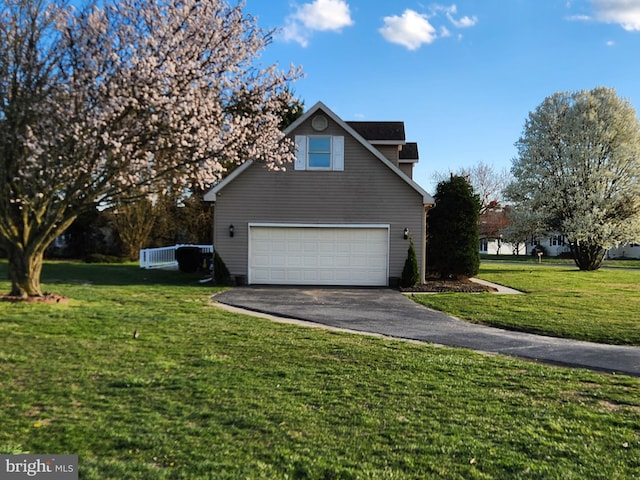 view of property exterior with a lawn and a garage