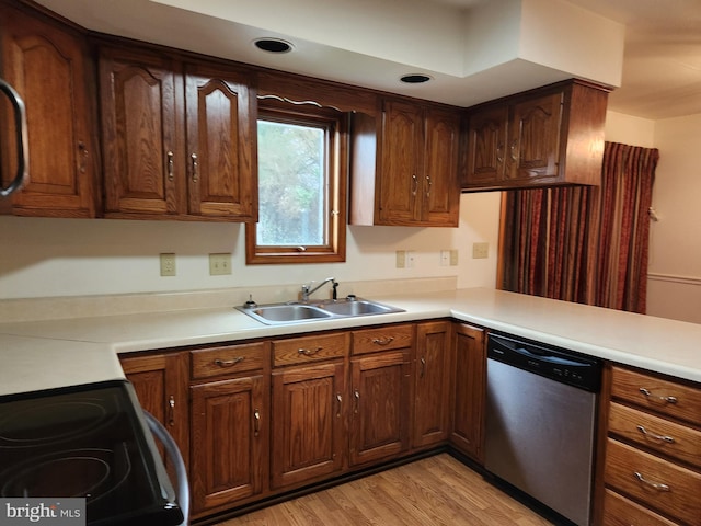 kitchen featuring sink, stainless steel dishwasher, stove, and light hardwood / wood-style flooring