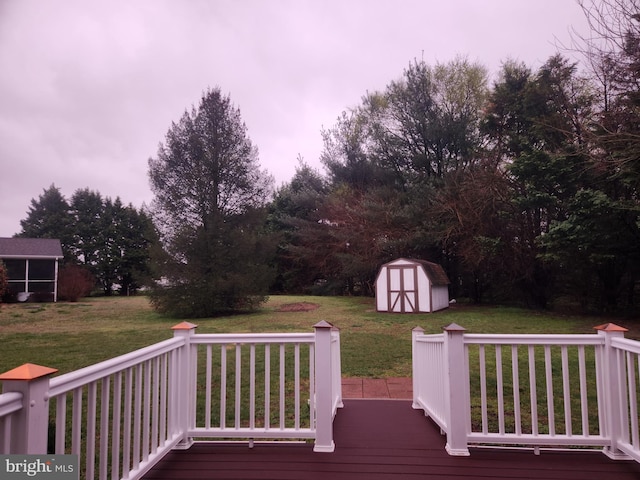 deck at dusk featuring a yard and a shed