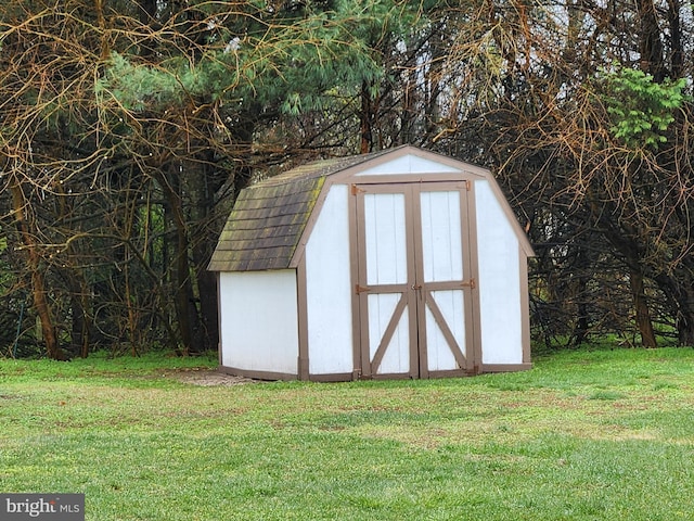 view of outbuilding featuring a yard