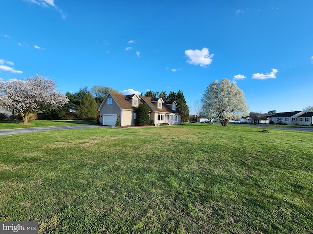 exterior space featuring a front lawn and a garage