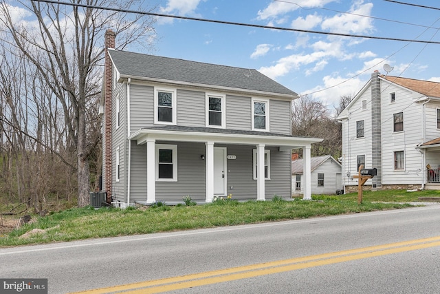 view of front property featuring central AC unit and covered porch