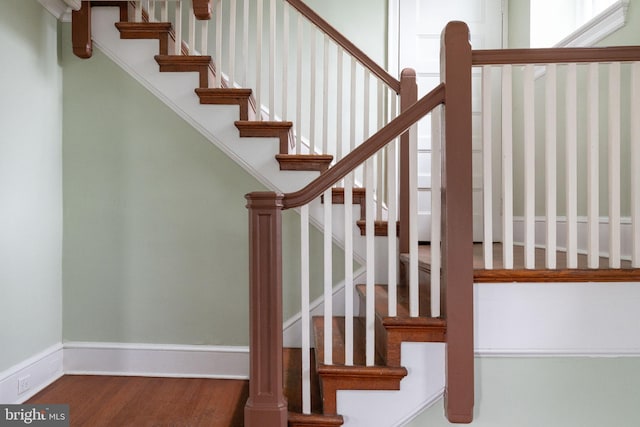 stairs featuring dark hardwood / wood-style floors