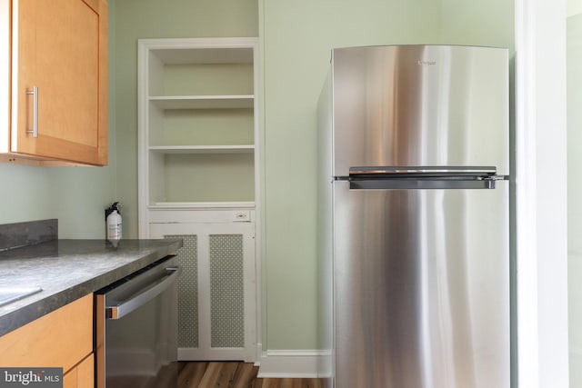 kitchen featuring dark hardwood / wood-style floors and stainless steel appliances