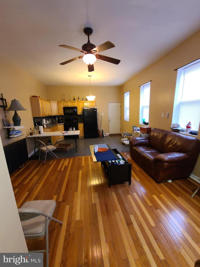 living room featuring ceiling fan, a healthy amount of sunlight, and hardwood / wood-style flooring