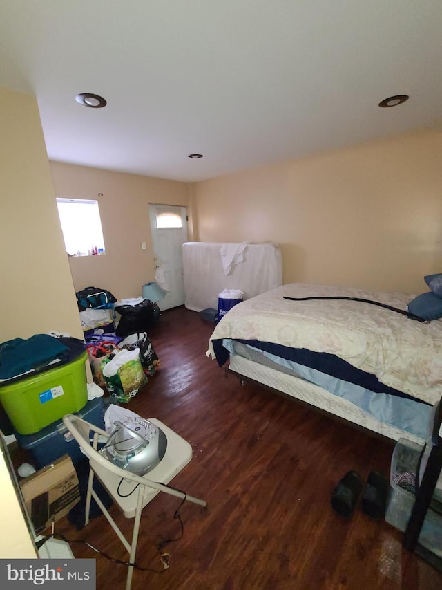 bedroom with dark hardwood / wood-style flooring