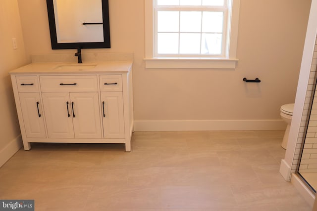 bathroom featuring tile patterned floors, vanity, toilet, and walk in shower