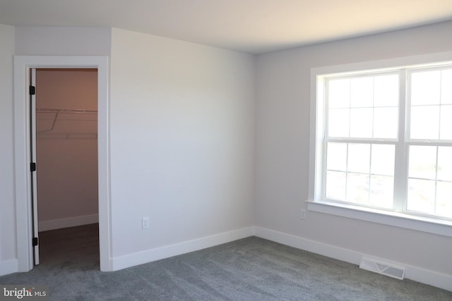 carpeted spare room with plenty of natural light