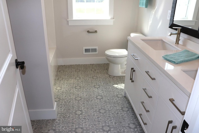 bathroom featuring tile patterned floors, vanity, and toilet