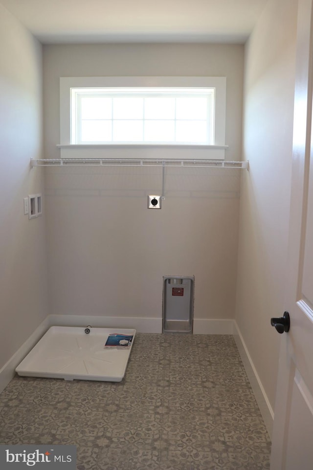 clothes washing area featuring hookup for a washing machine, a healthy amount of sunlight, and hookup for an electric dryer