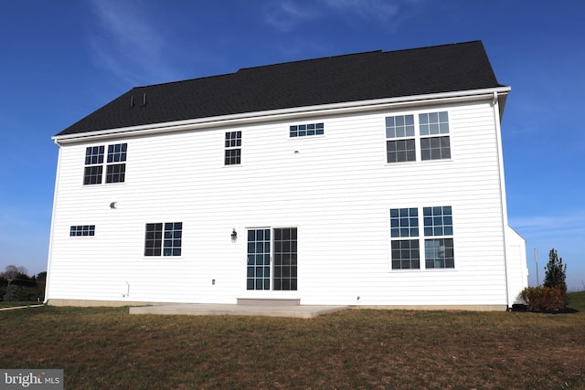 rear view of property with a yard and a patio