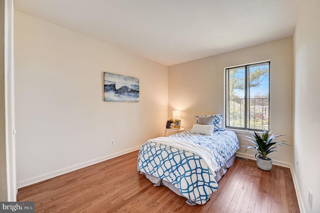 bedroom with hardwood / wood-style flooring