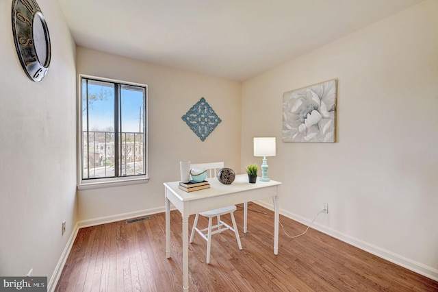 office area with hardwood / wood-style floors