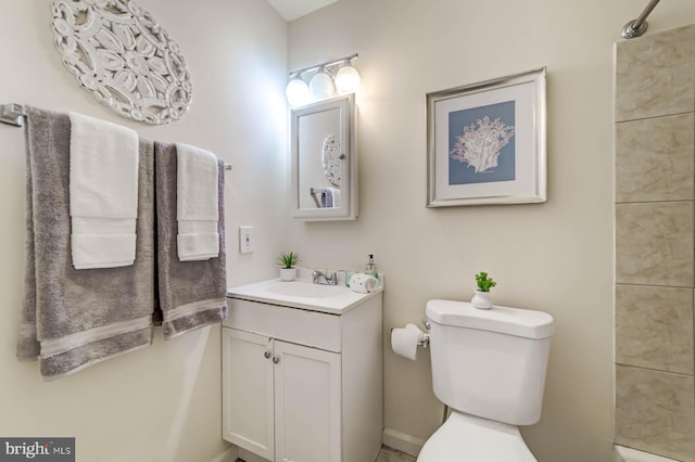 bathroom featuring toilet and vanity