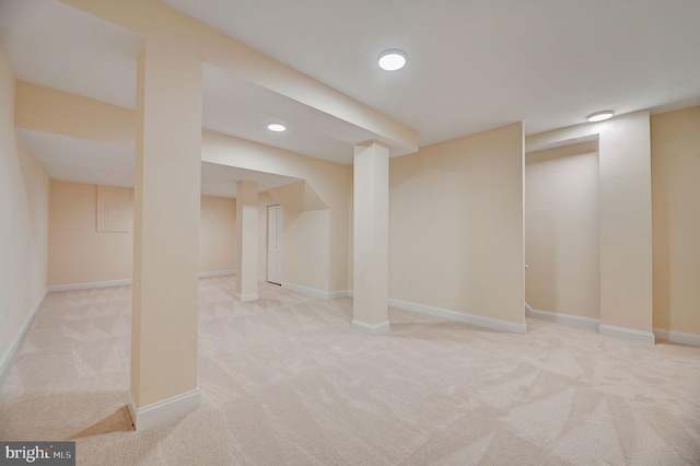 basement featuring light colored carpet