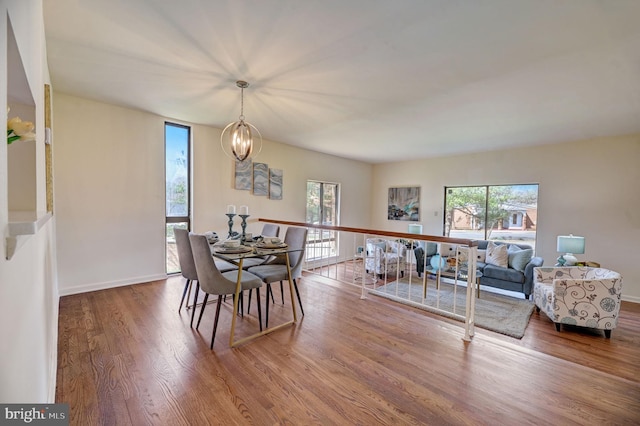 dining area featuring an inviting chandelier and hardwood / wood-style floors