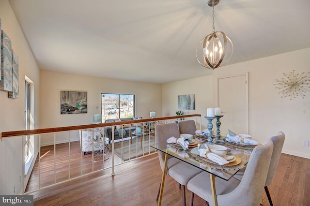 dining area with an inviting chandelier and hardwood / wood-style floors