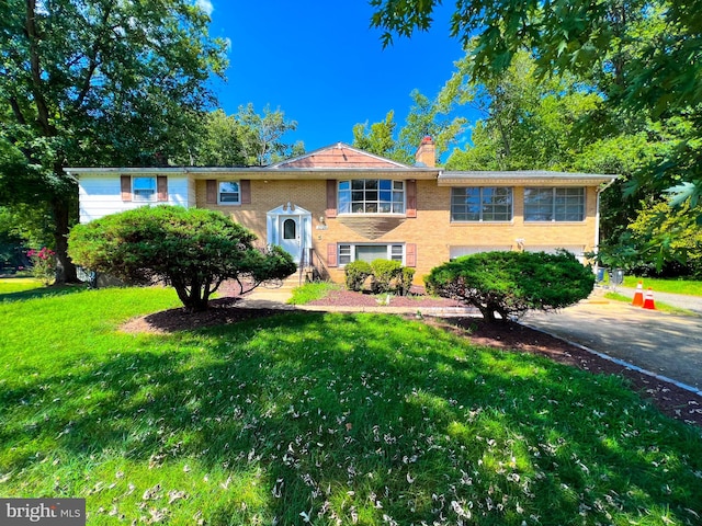 raised ranch featuring a front yard