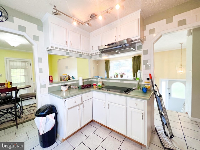 kitchen featuring white cabinetry, hanging light fixtures, and light tile flooring