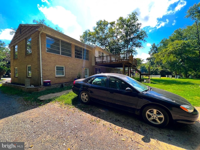 view of home's exterior with a lawn and a wooden deck