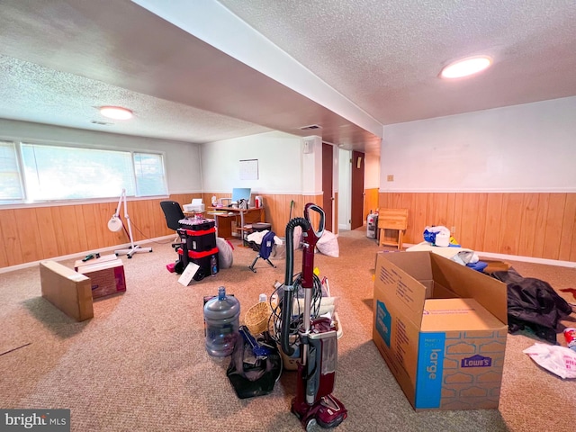 recreation room featuring carpet flooring and a textured ceiling