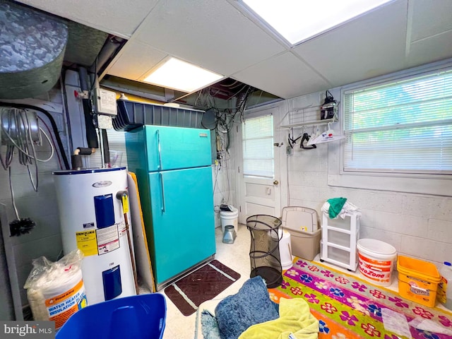 garage with white refrigerator and electric water heater