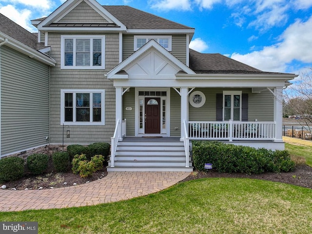 view of front facade with a front lawn and covered porch