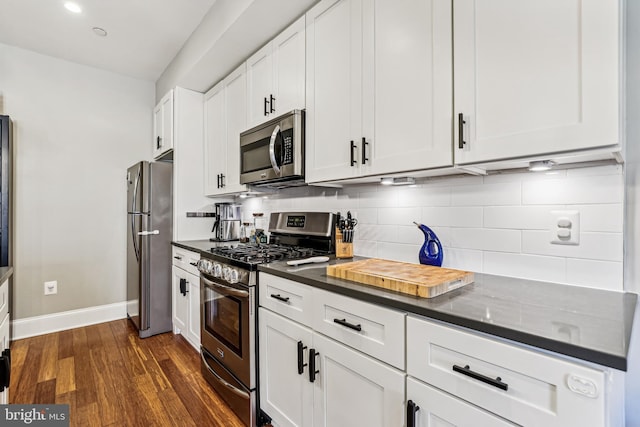 kitchen featuring white cabinets, backsplash, dark hardwood / wood-style floors, and stainless steel appliances