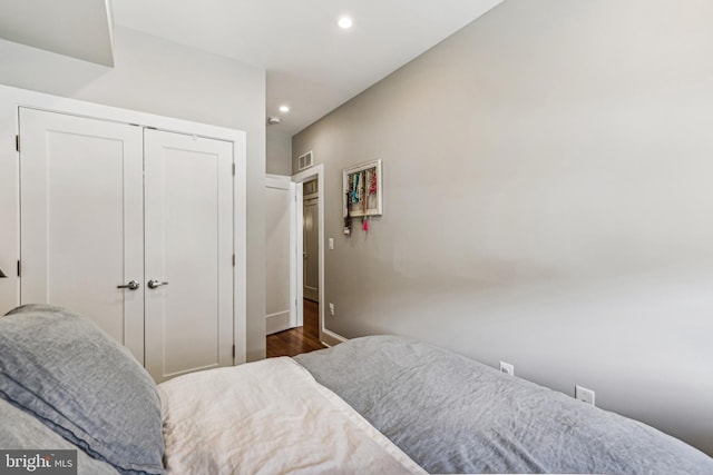 bedroom with a closet and dark hardwood / wood-style flooring