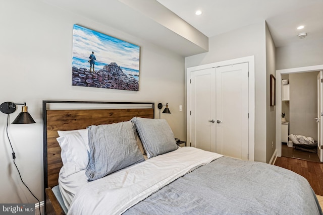 bedroom with a closet and dark hardwood / wood-style floors