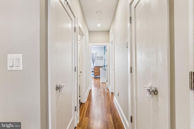 corridor featuring dark hardwood / wood-style flooring