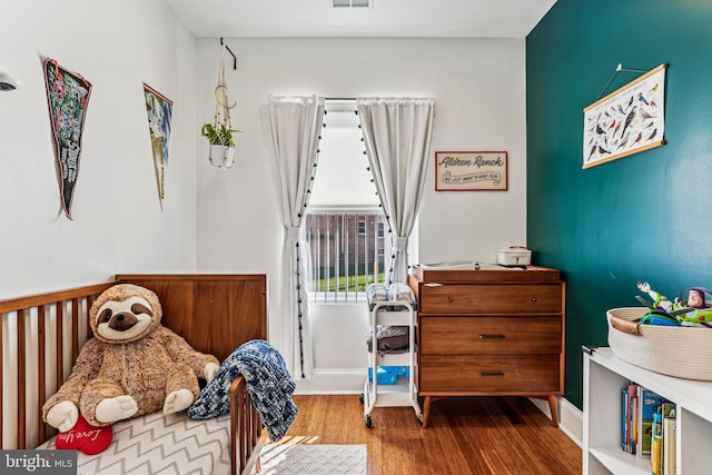 bedroom with hardwood / wood-style floors