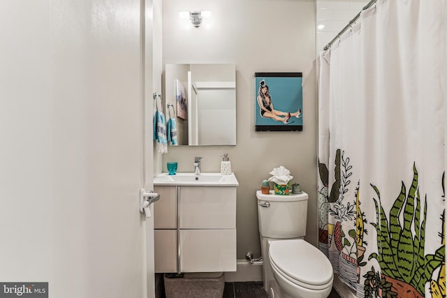 bathroom featuring toilet and vanity